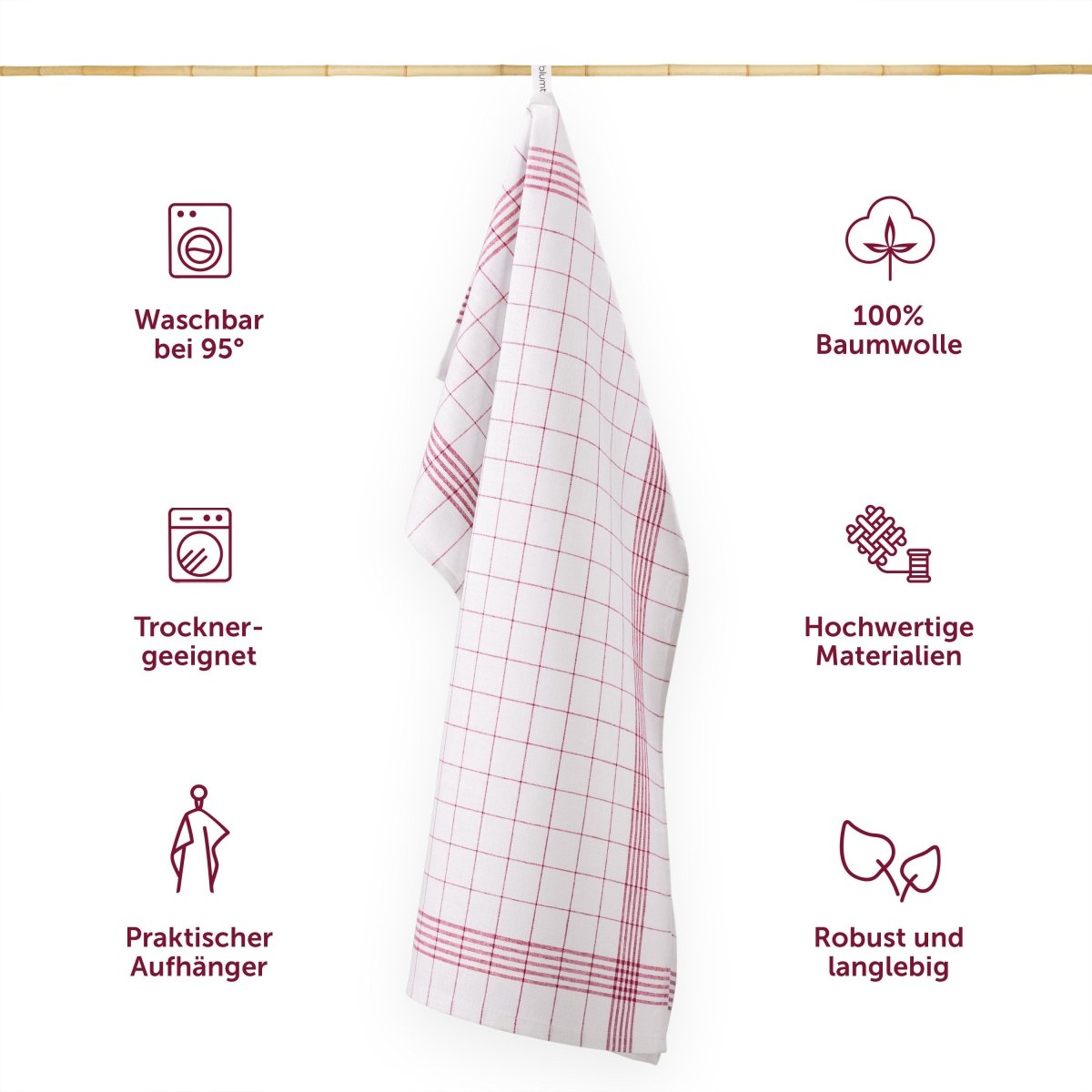 Geschirrtuch hängt an einer Leiste mit Symbolen für Waschbarkeit Materialqualität und praktischen Eigenschaften.