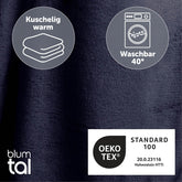 Detailansicht des dunkelblau flauschigen Stoffes mit Symbolen für Kuschelwärme und Waschbarkeit bei 40 Grad sowie OEKO-TEX Standard 100 Zertifizierung.