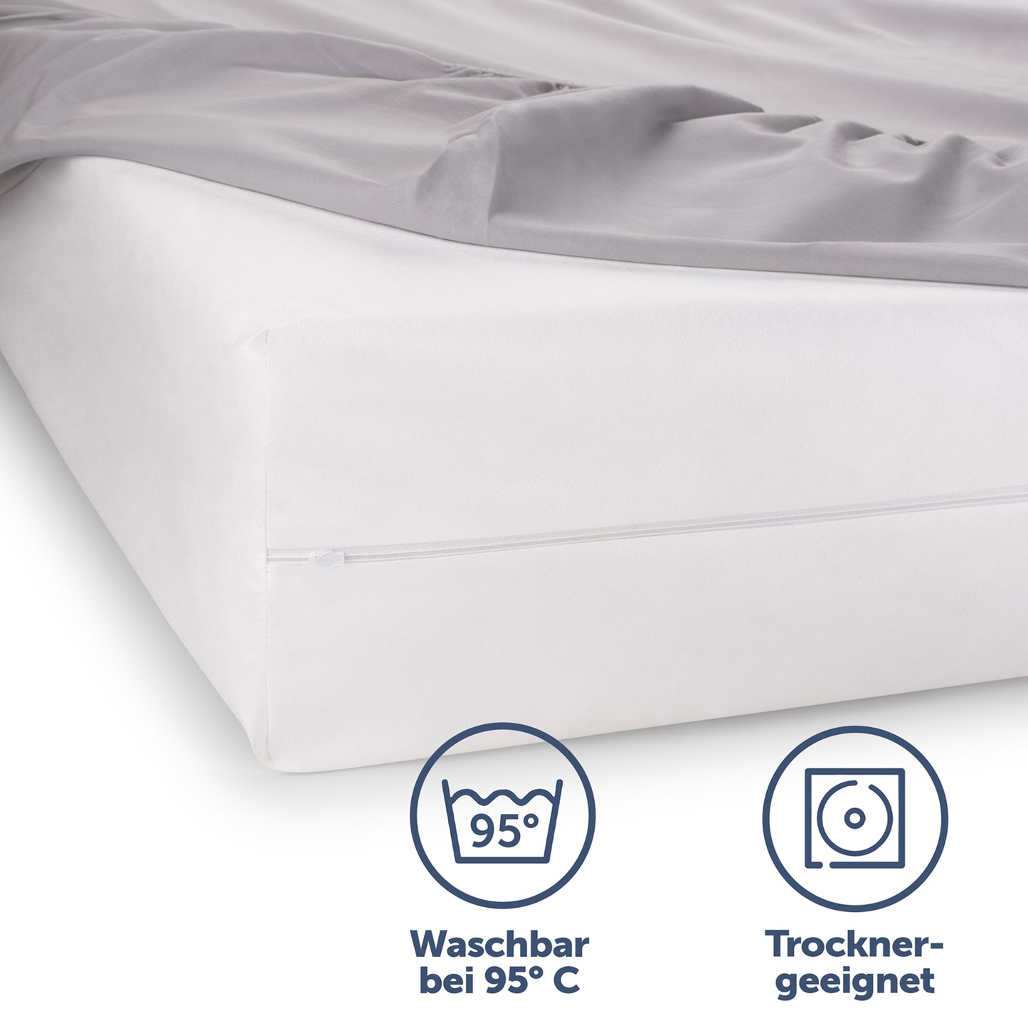 Matratzenbezug auf einem Bett hervorgehoben durch seine Waschbarkeit bei 95°C und Trocknereignung für einfache Pflege.