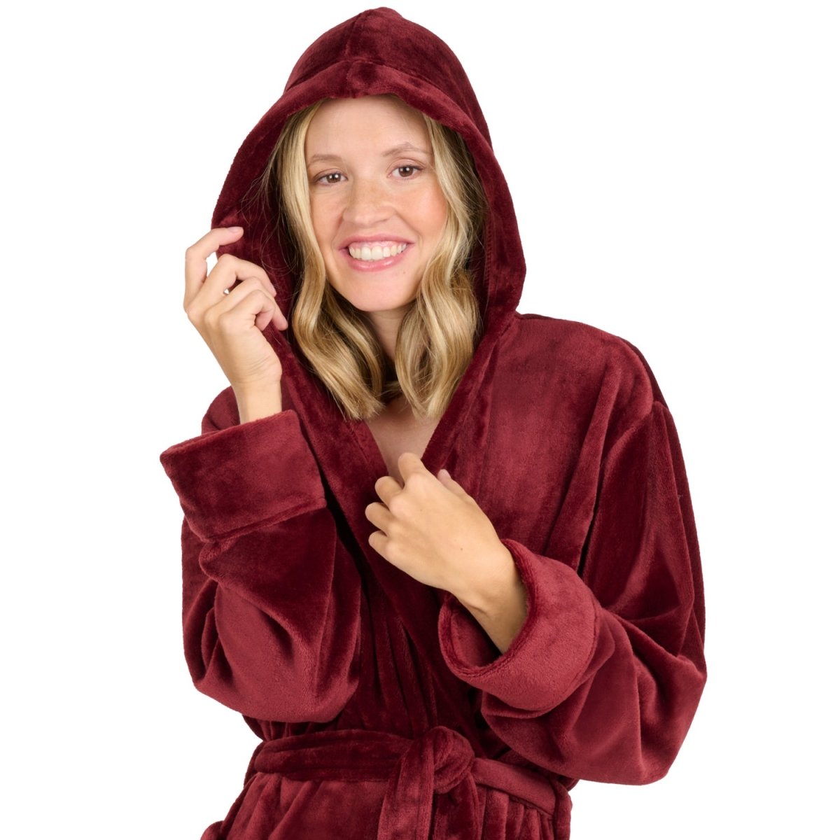 Eine Frau mit einem Fleece-Bademantel die lächelnd die Kapuze über den Kopf gezogen hat isoliert auf weißem Hintergrund.