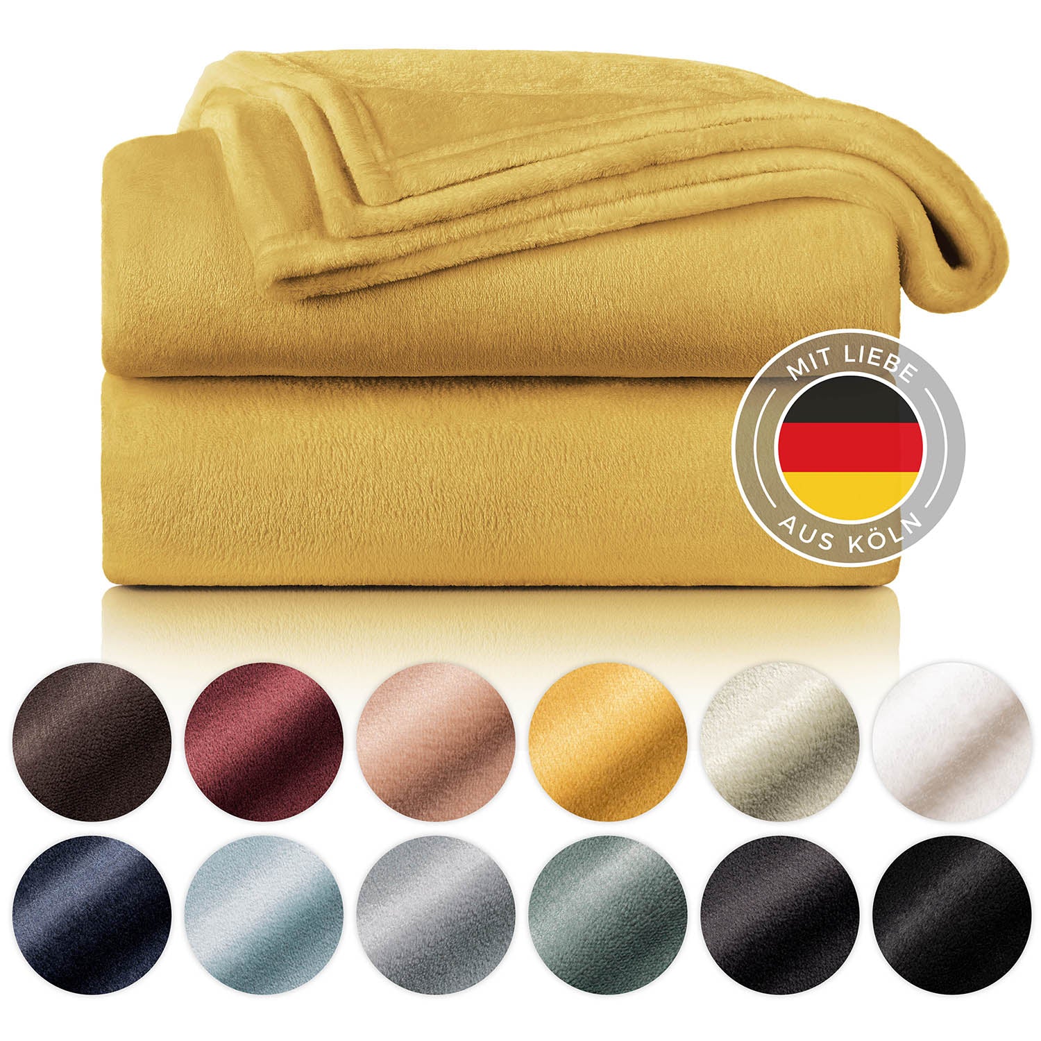 Gefaltete senfgelbe Fleece-Kuscheldecke, präsentiert neben einer Farbpalette und einem Label 'Mit Liebe aus Köln'.