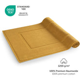 Gelbes Handtuch mit OEKO-TEX Label und Grammaturangabe.