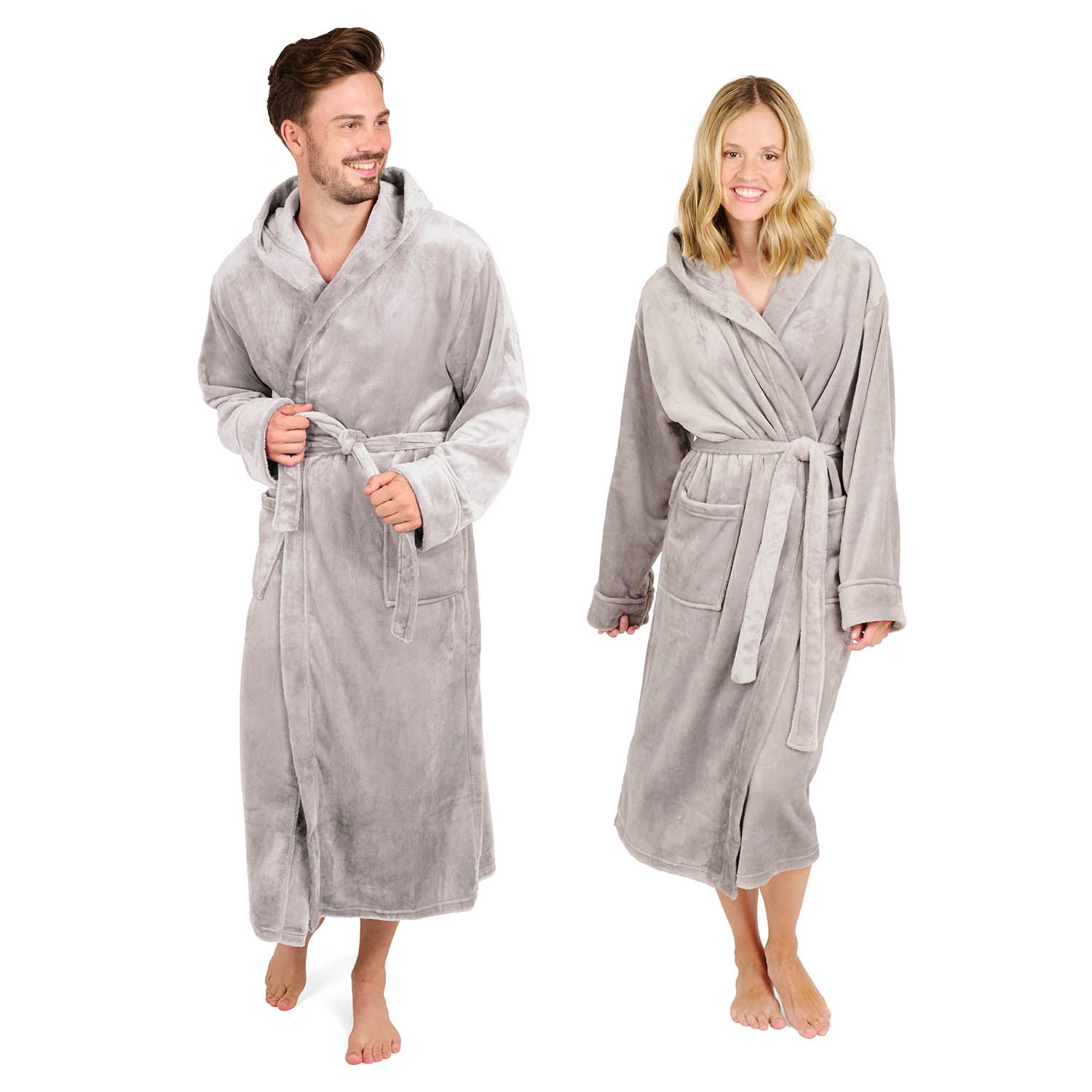 Ein Mann und eine Frau die lächelnd Fleece-Bademäntel mit Schalkragen und Bindegürtel tragen isoliert auf weißem Hintergrund.