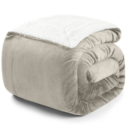 Zusammengerollte beige Decke mit weißer Fleece-Innenseite auf weißem Hintergrund.