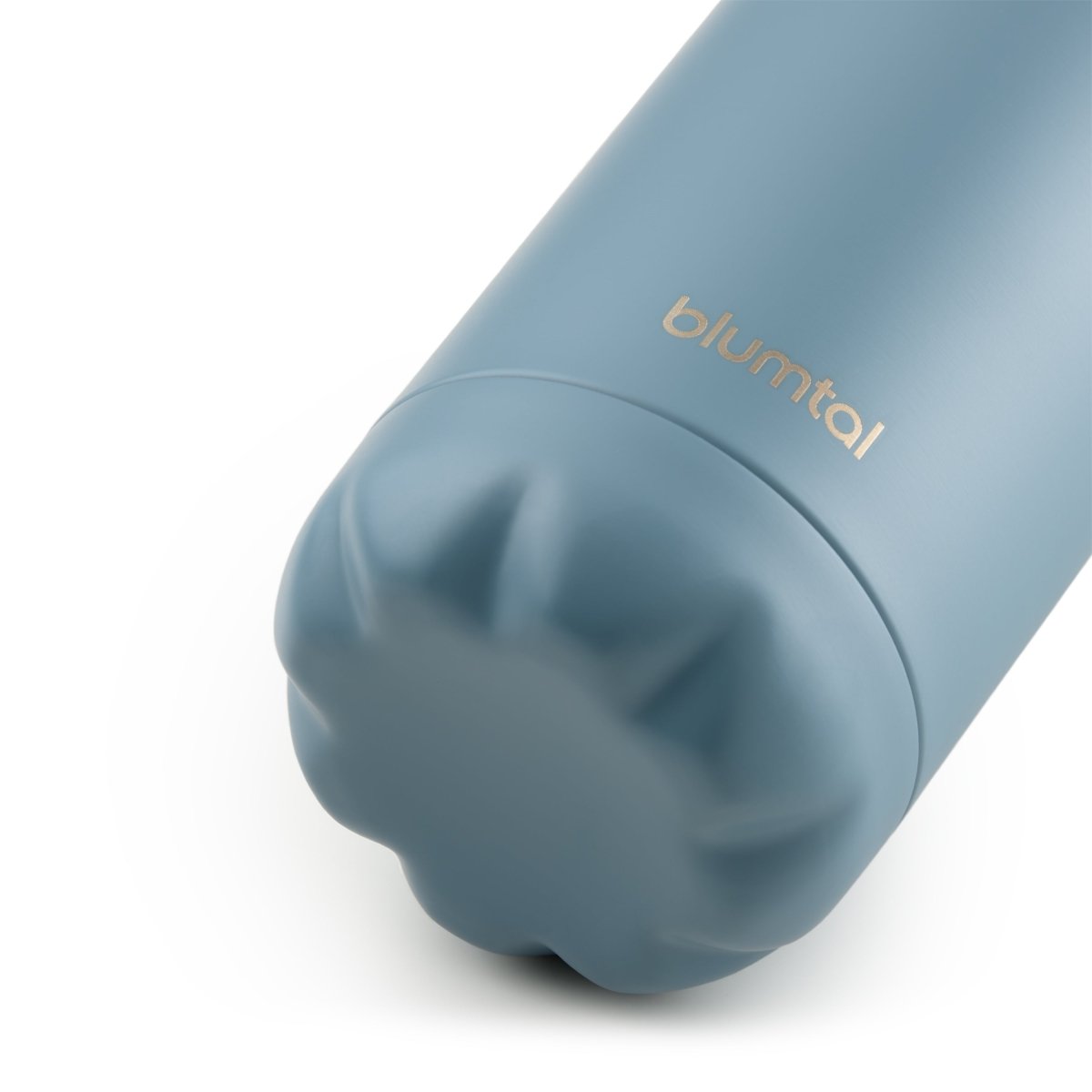 Nahaufnahme des Bodens einer grau blau blumtal Edelstahl-Trinkflasche die auf einer weißen Oberfläche steht.