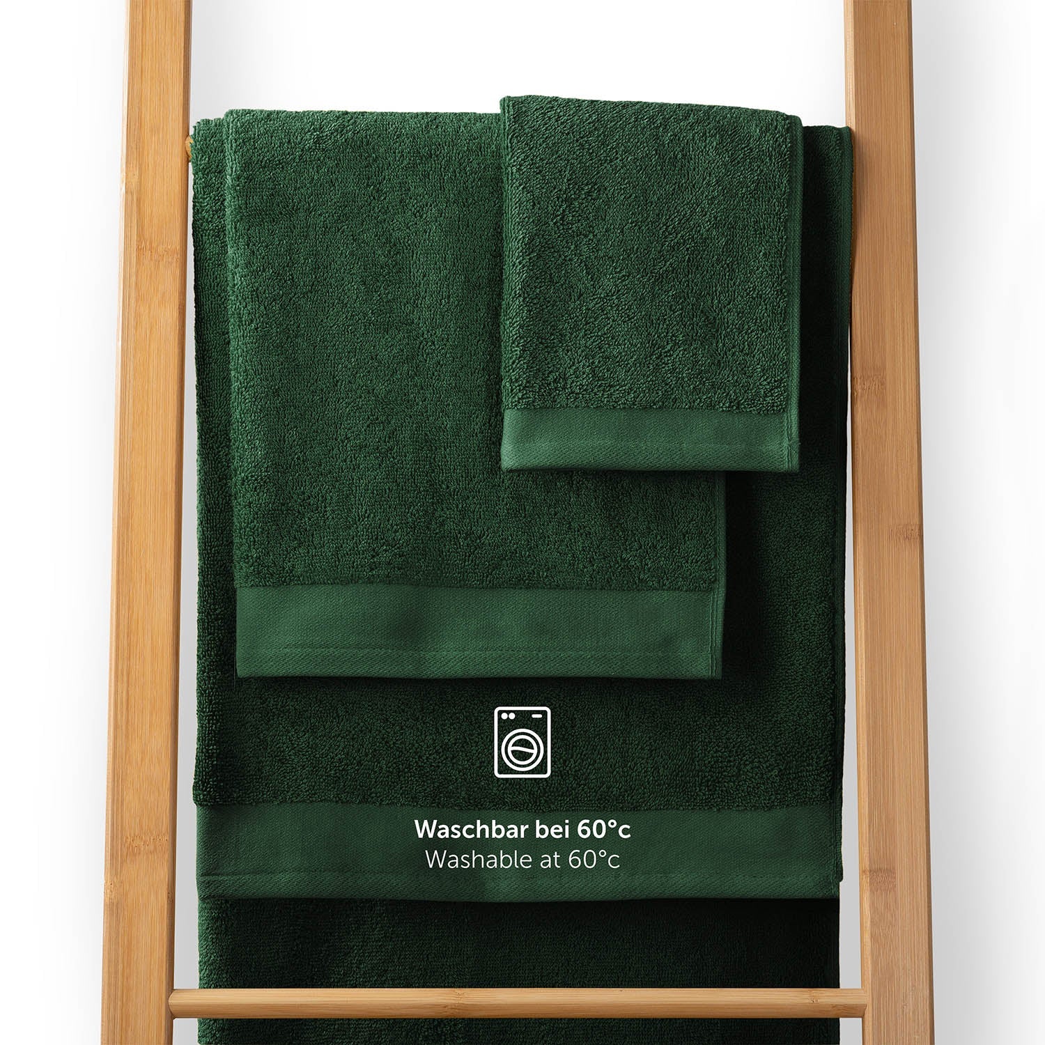 Handtücher auf einem Holzhandtuchhalter mit Pflegehinweis Waschbar bei 60°C in weißer Schrift